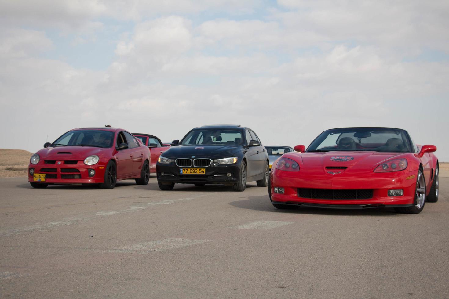 Cars on the race track and on the roads of the desert photo