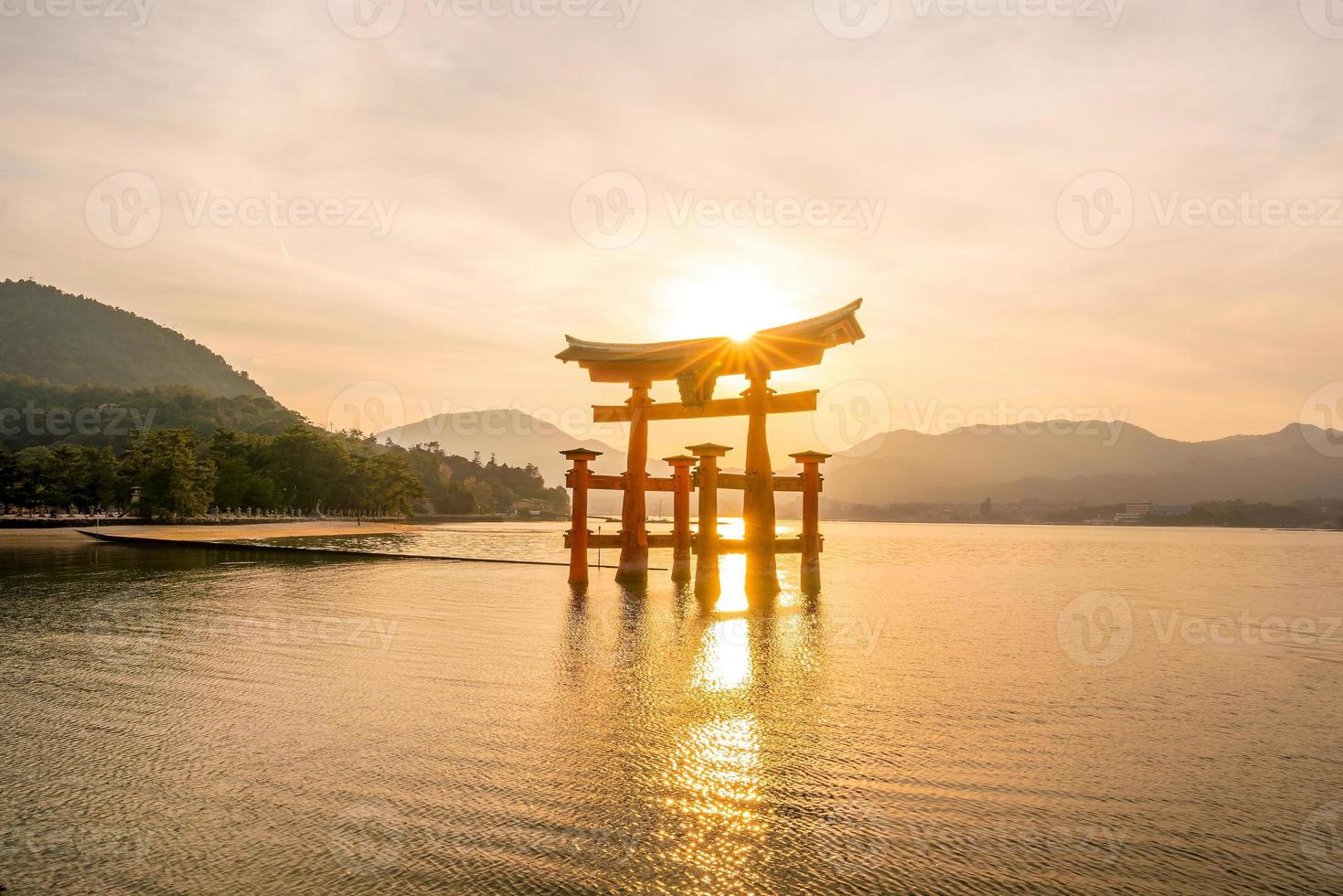 The floating gate of Itsukushima Shrine at sunset photo