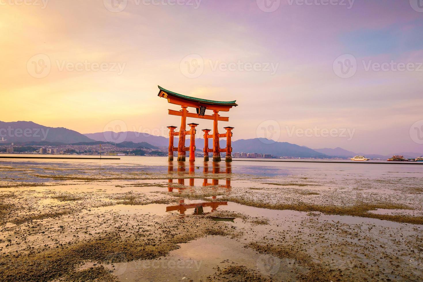 The floating gate of Itsukushima Shrine at sunset photo