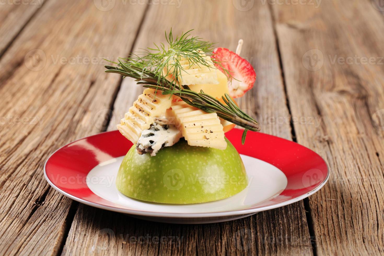 Various types of cheese on an apple photo
