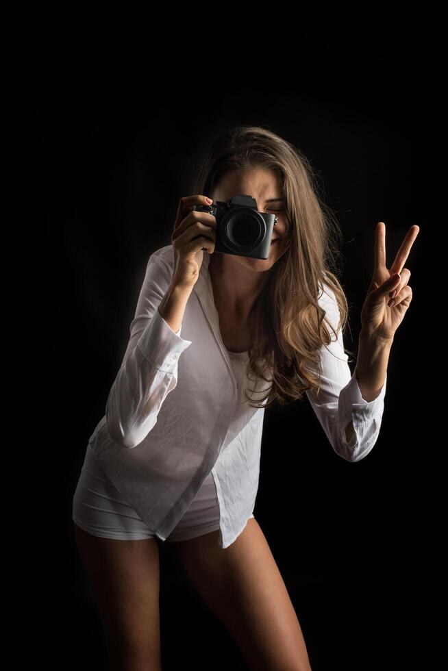 Fashion portrait of young woman photographer with camera photo