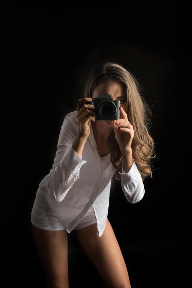 Fashion portrait of young woman photographer with camera photo