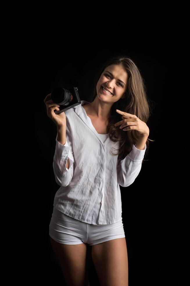 Fashion portrait of young woman photographer with camera photo