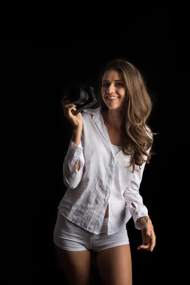 Fashion portrait of young woman photographer with camera photo