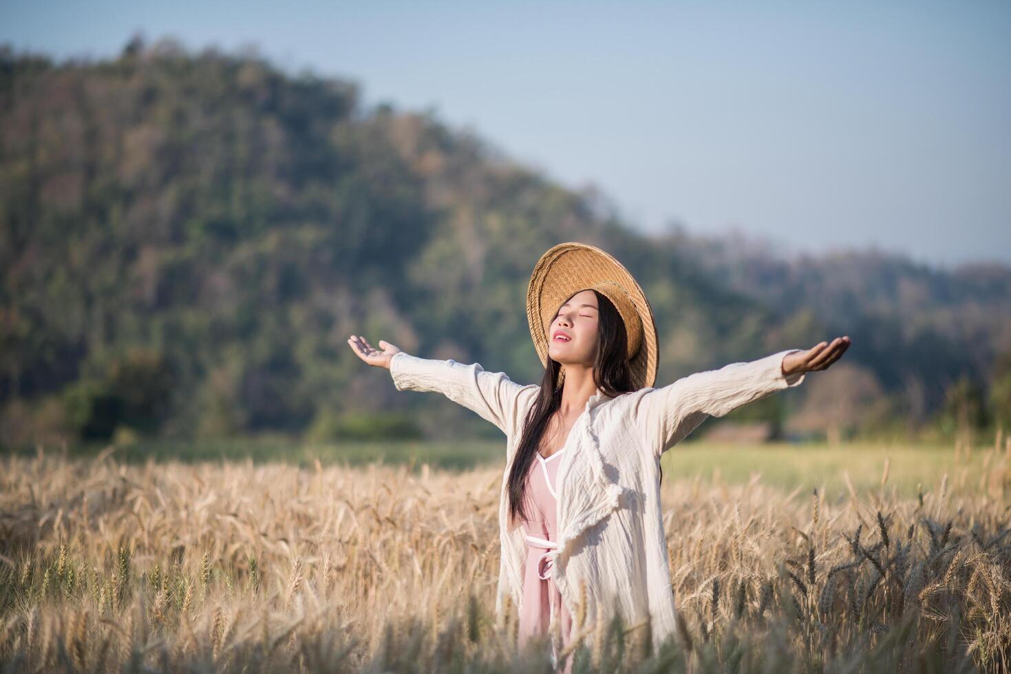 Vietnamese female farmer in wheat harvest field photo