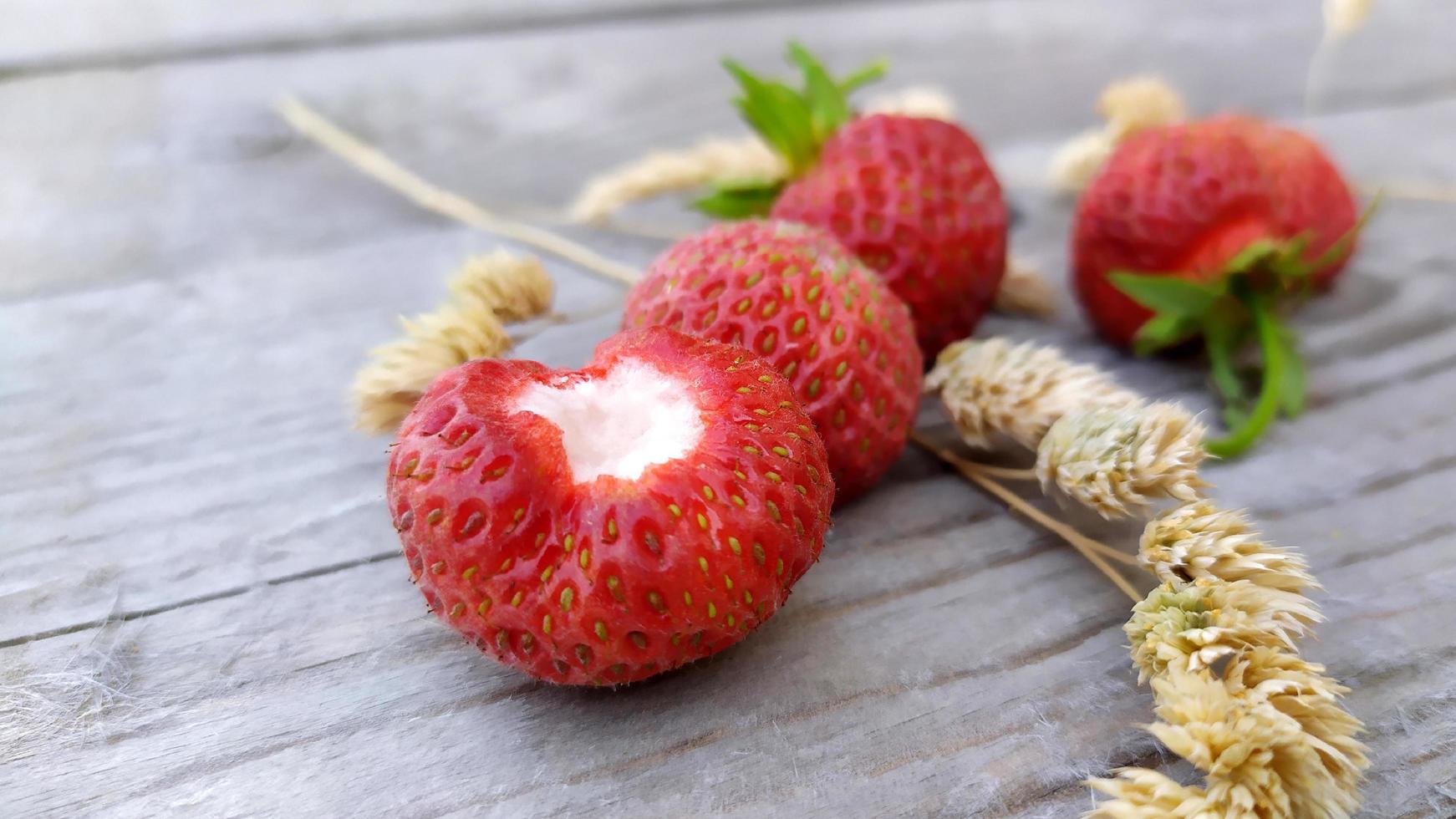 Strawberry close-up with dry sprigs of cereals photo