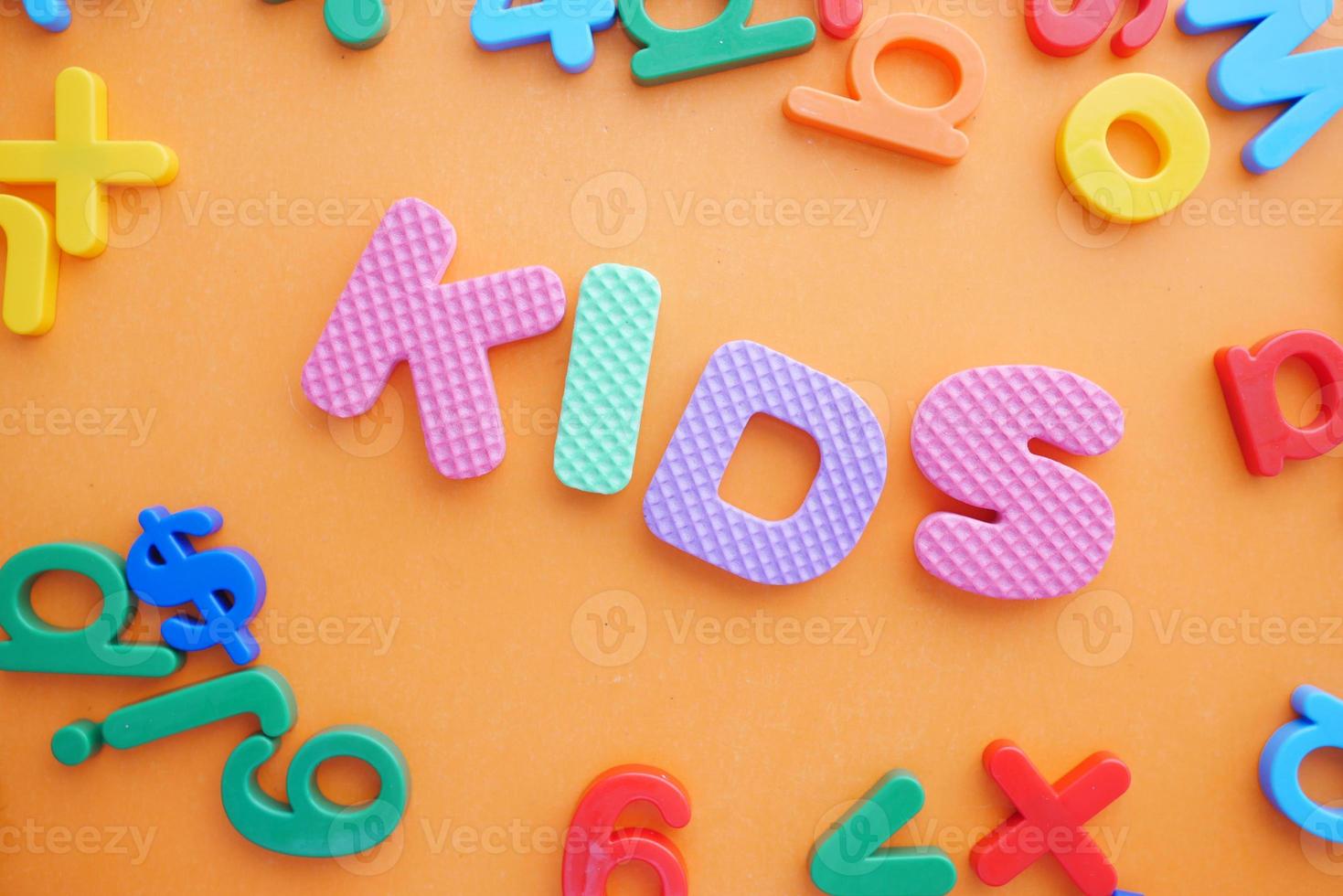 colorful plastic letters on orange background, Top view photo