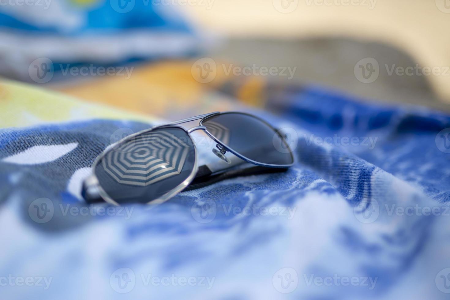 Reflecting sunglasses on the beach photo