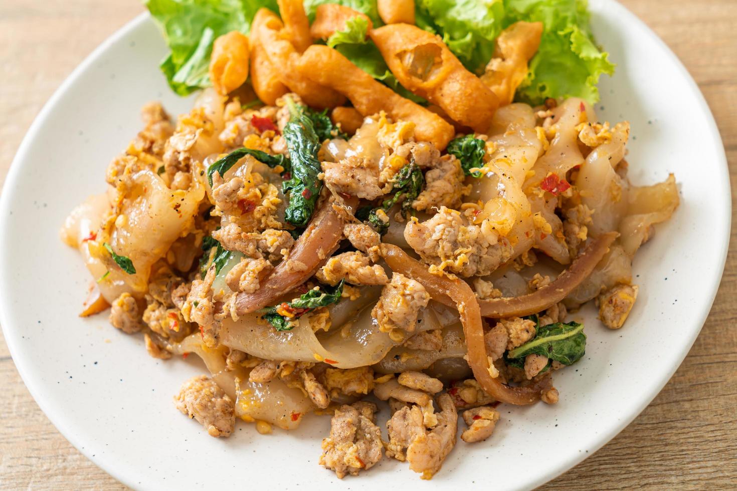 Stir-fried noodle with minced chicken and basil photo