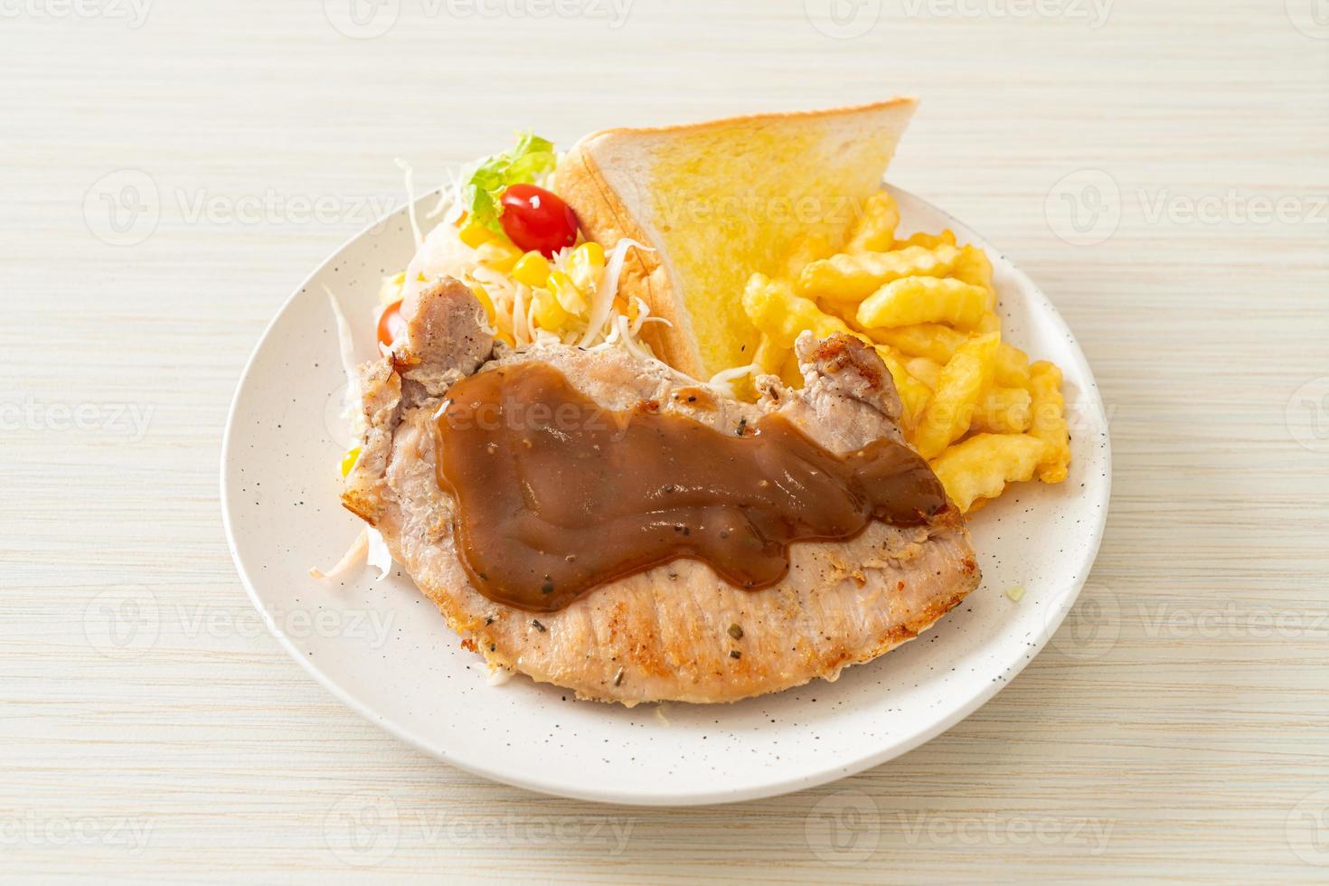 Pork steak with black peppers gravy sauce and mini salad photo
