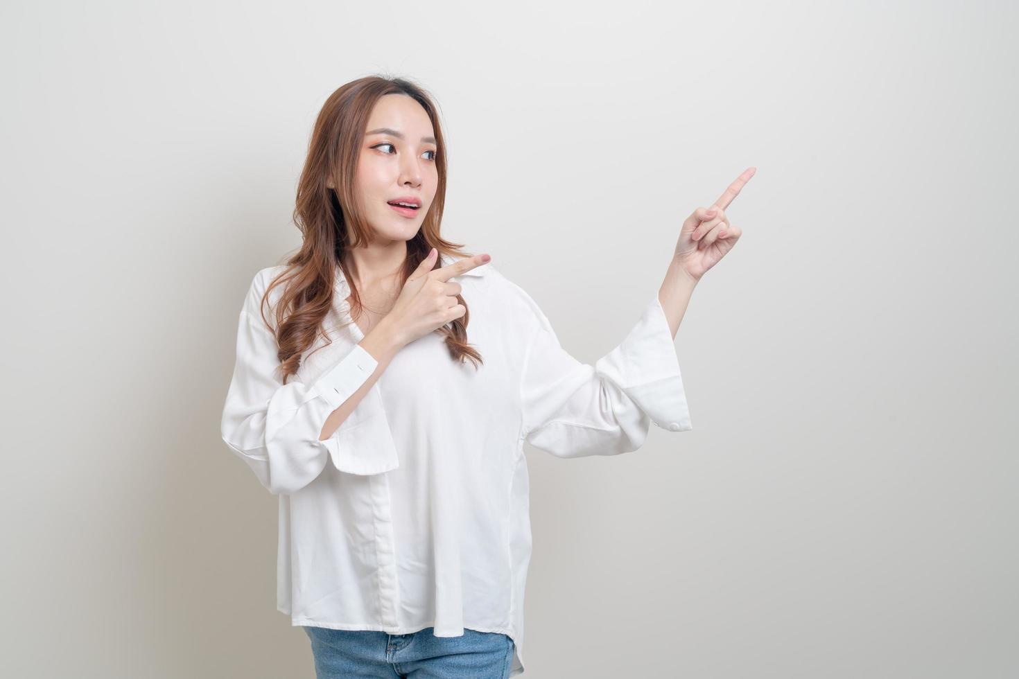 Portrait beautiful Asian woman with hand presenting or pointing on white background photo