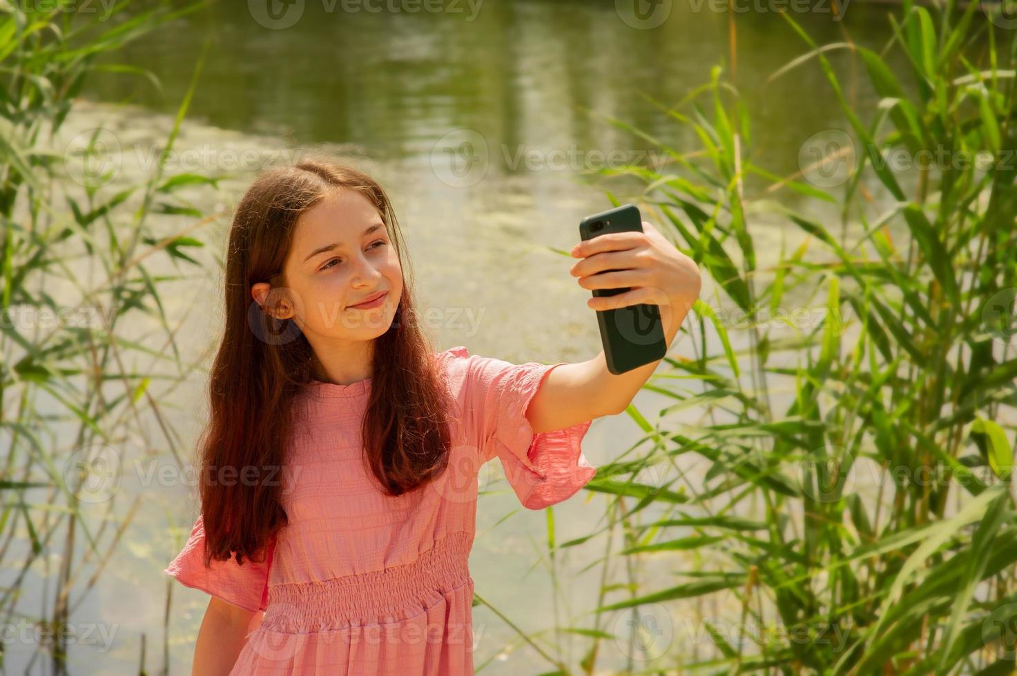 A beautiful girl makes a selfie photo