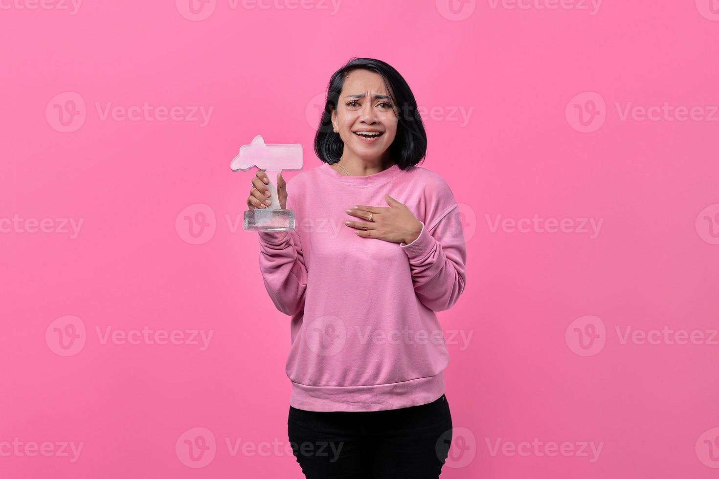 Young woman holding an award photo