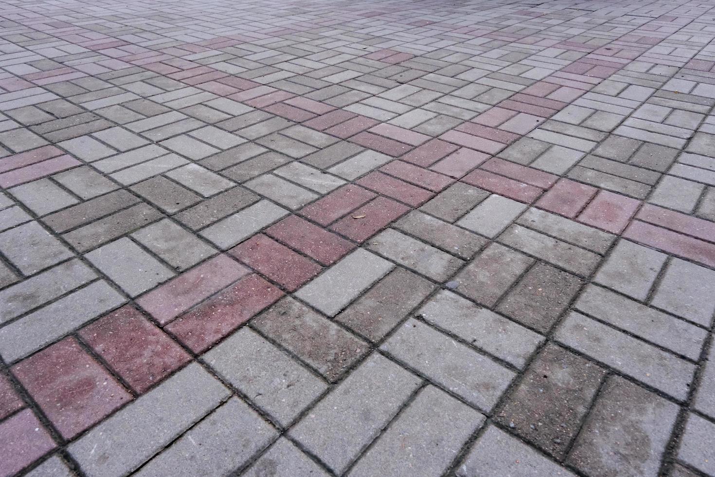 Pavement pattern made of paving stone tiles with textured surface photo