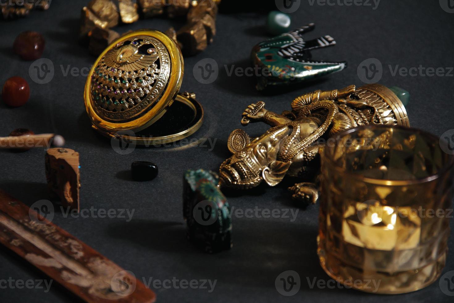 Table with occult attributes, top view. Ganesha figurine, photo