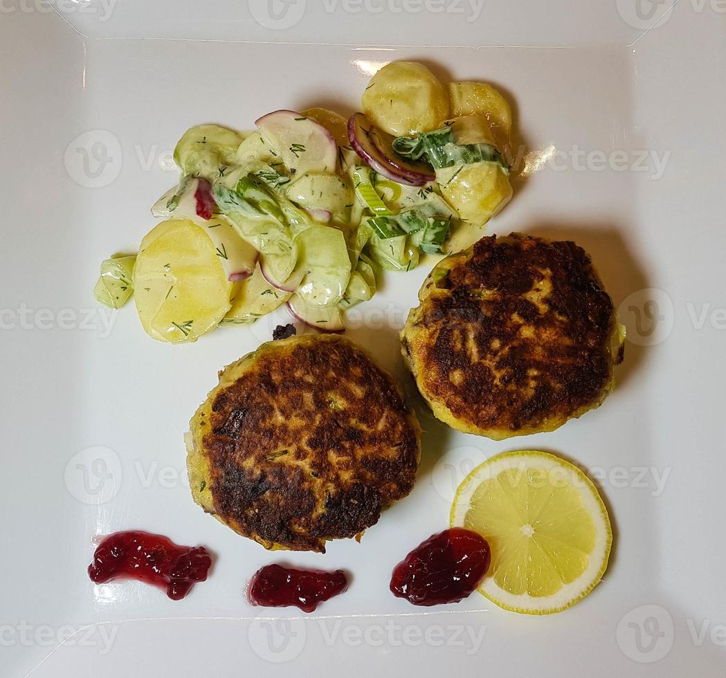 Fish cakes of smoked mackerel fillet with salad photo