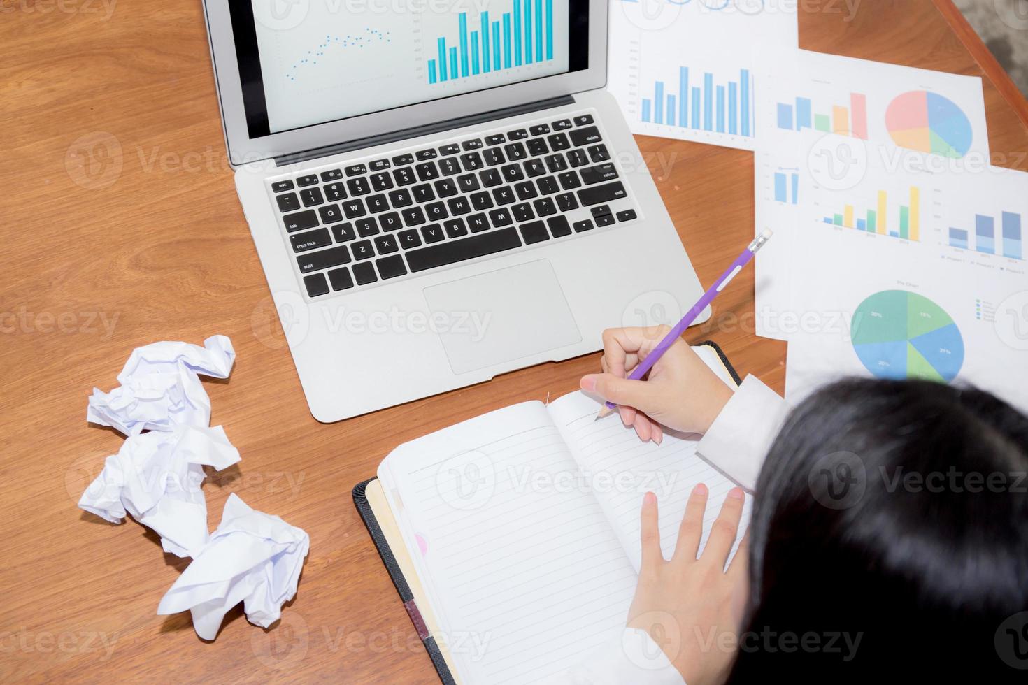 Business woman writing on notebook at desk. photo