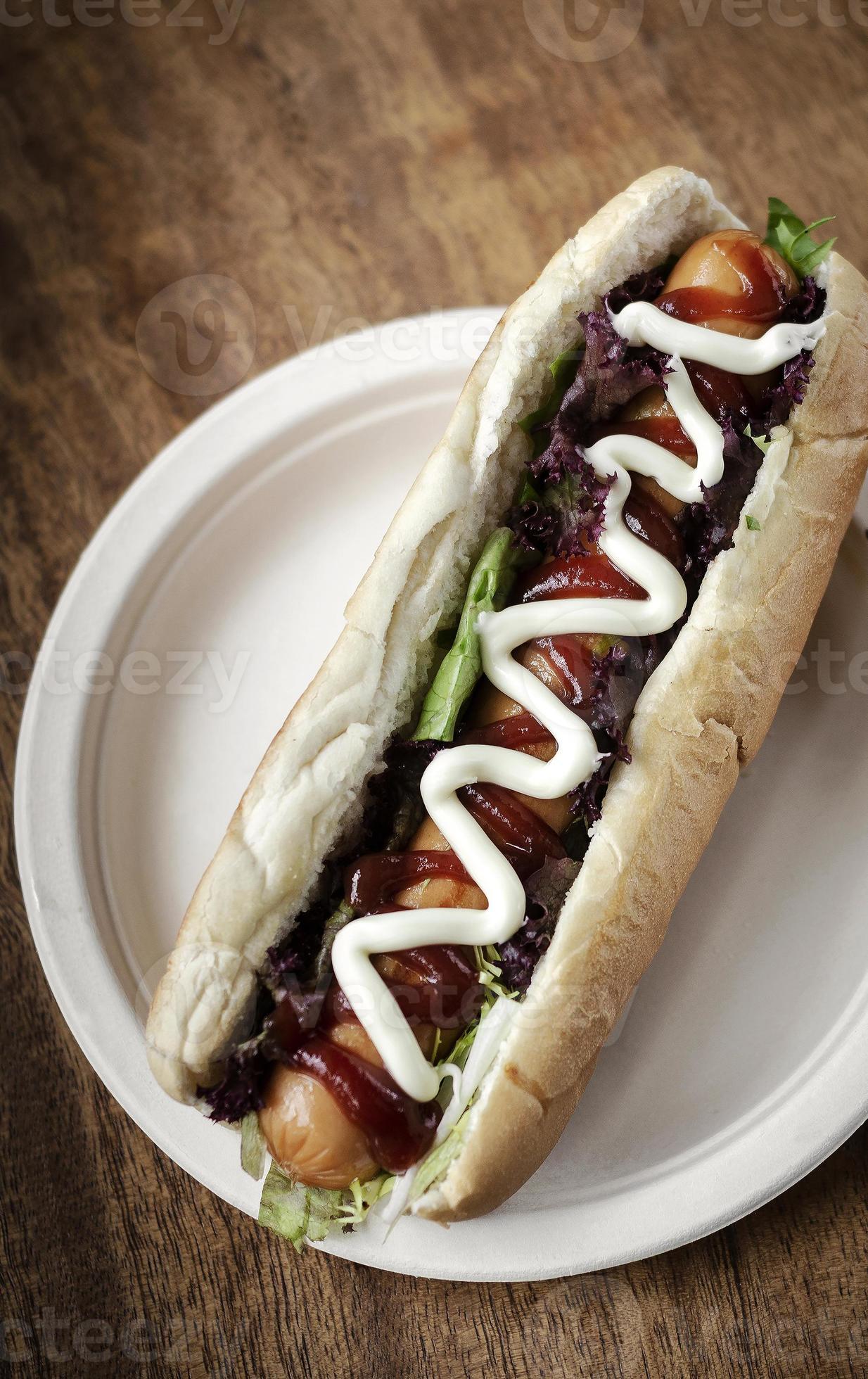 Classic hot dog with frankfurter sausage and sauces on wood table 3193676 Stock Photo at Vecteezy
