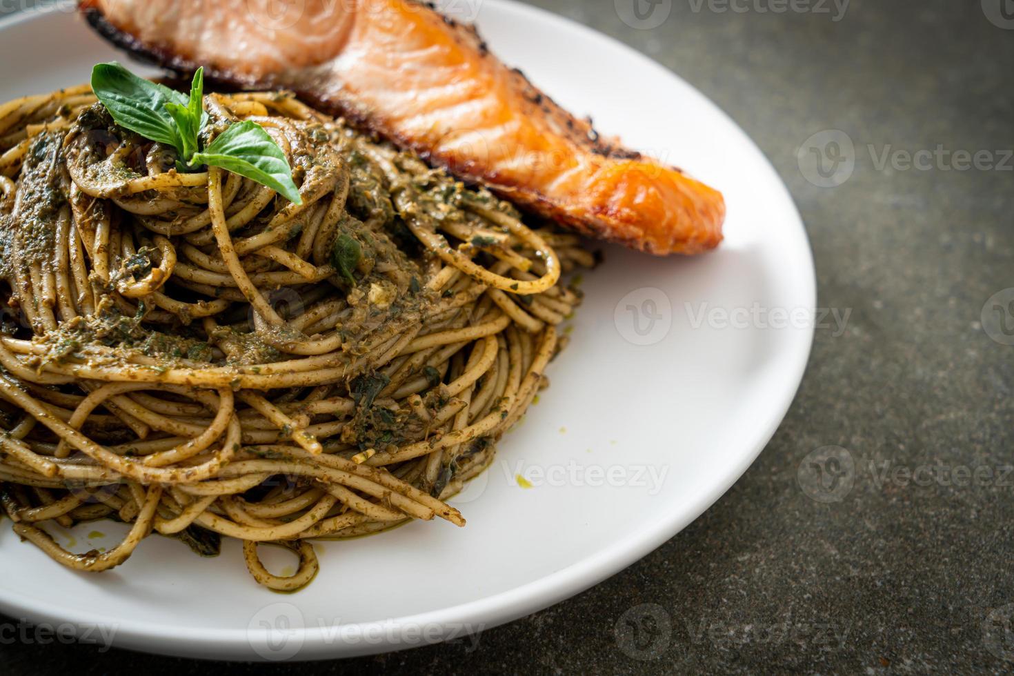 Homemade pesto spaghetti pasta with grilled salmon - Italian food style photo