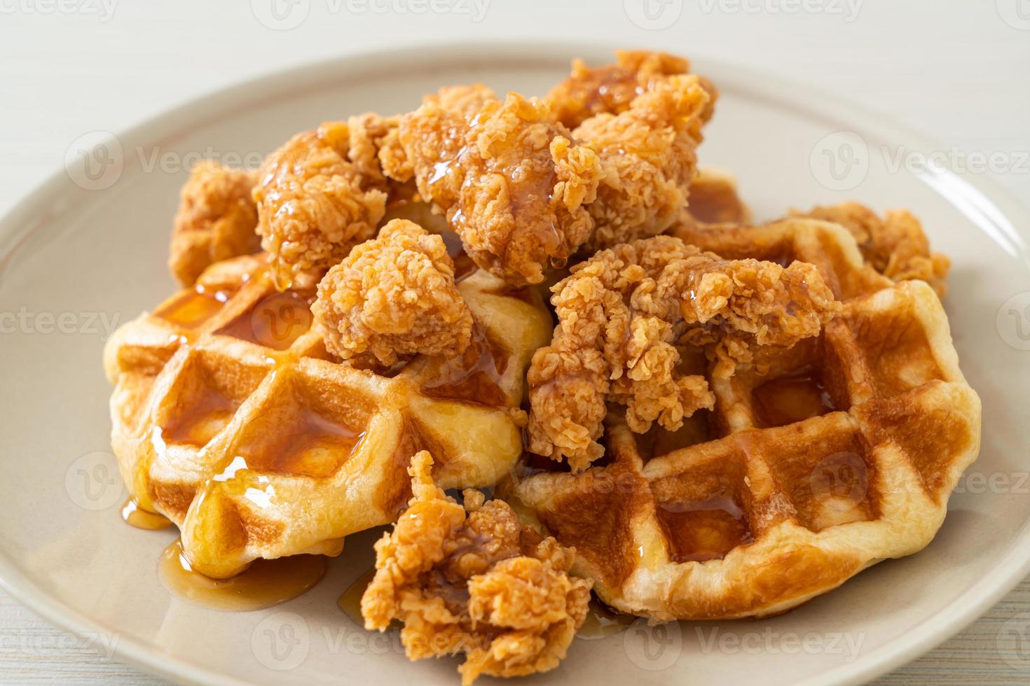 Homemade fried chicken waffle with honey or maple syrup photo