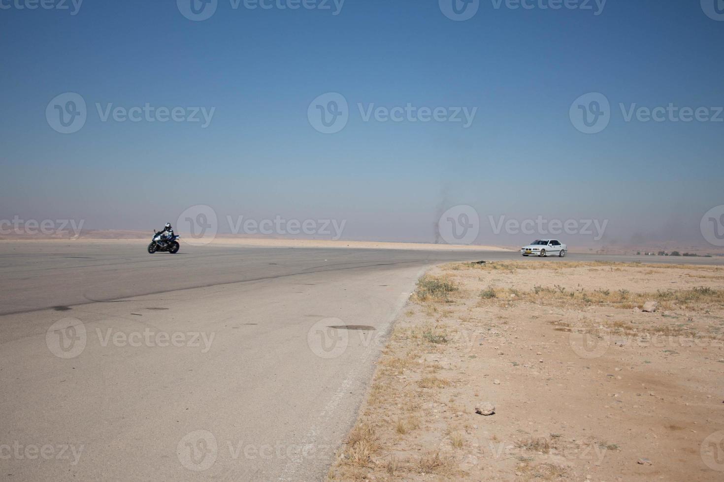 Cars on the race track and on the roads of the desert photo