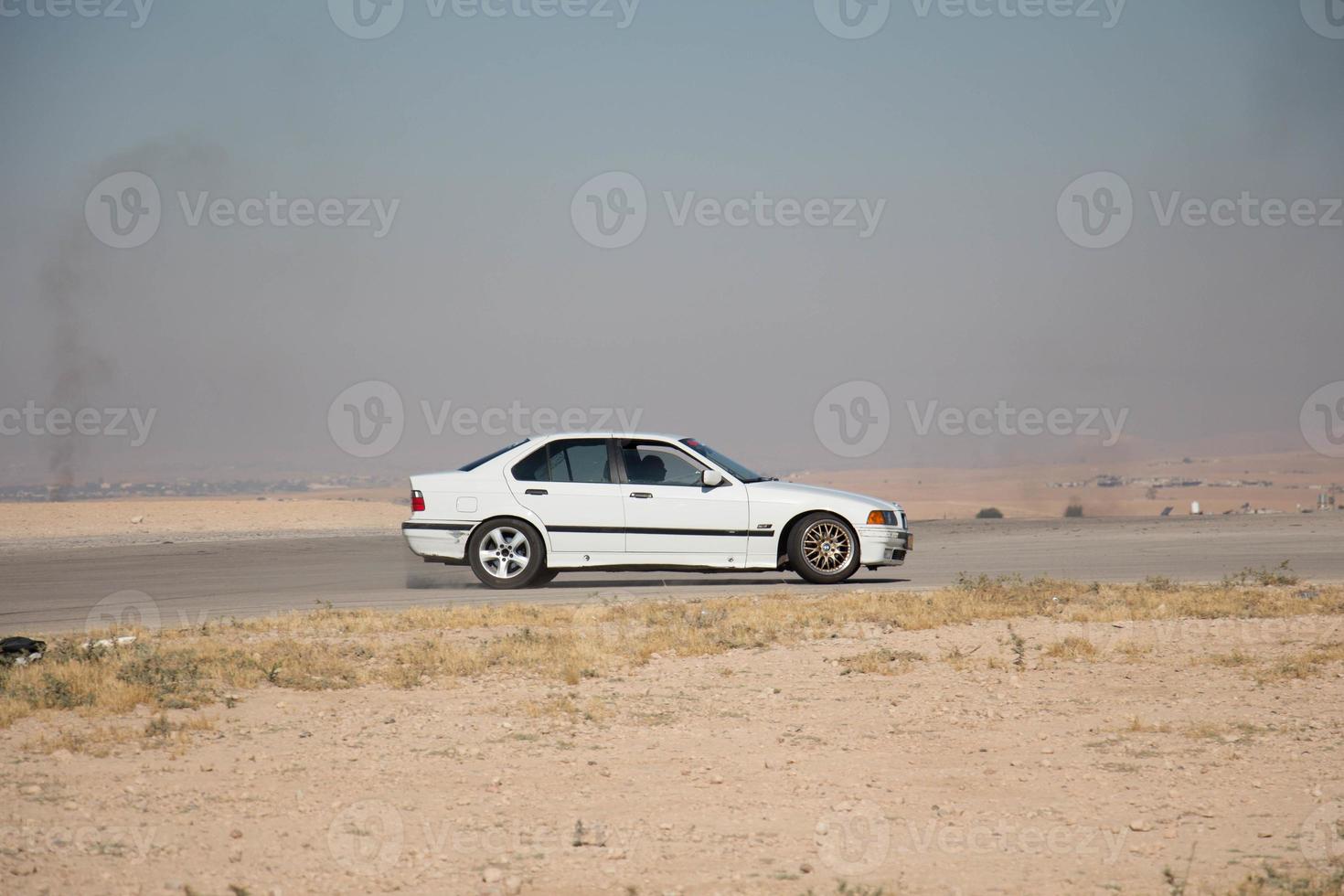 Cars on the race track and on the roads of the desert photo