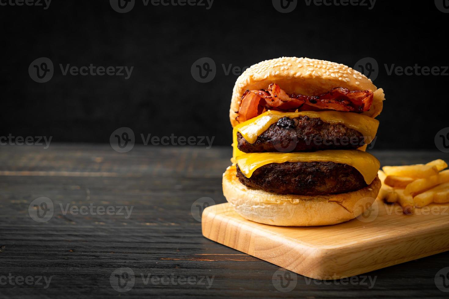 Hamburger or beef burgers with cheese and bacon - unhealthy food style photo