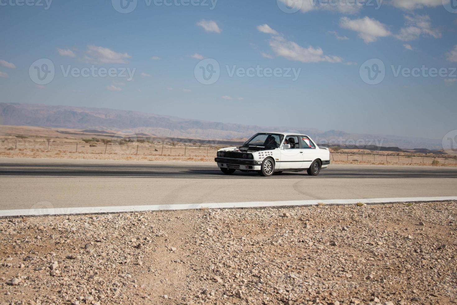 Cars on the race track and on the roads of the desert photo