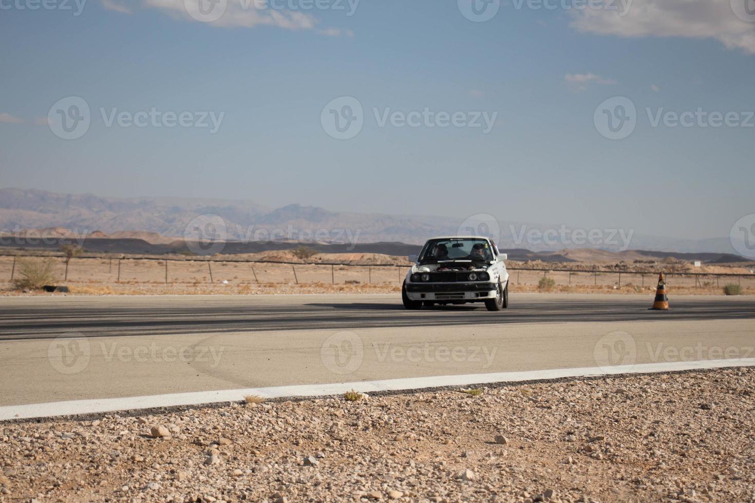 Cars on the race track and on the roads of the desert photo