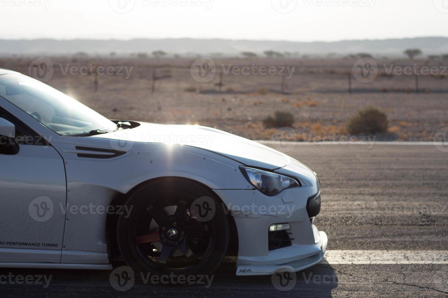 Cars on the race track and on the roads of the desert photo