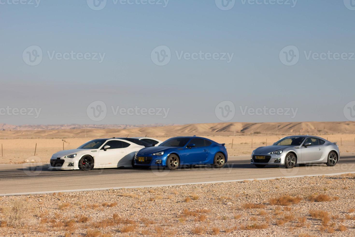 Cars on the race track and on the roads of the desert photo