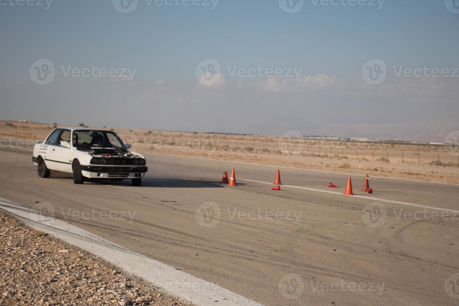 Cars on the race track and on the roads of the desert photo