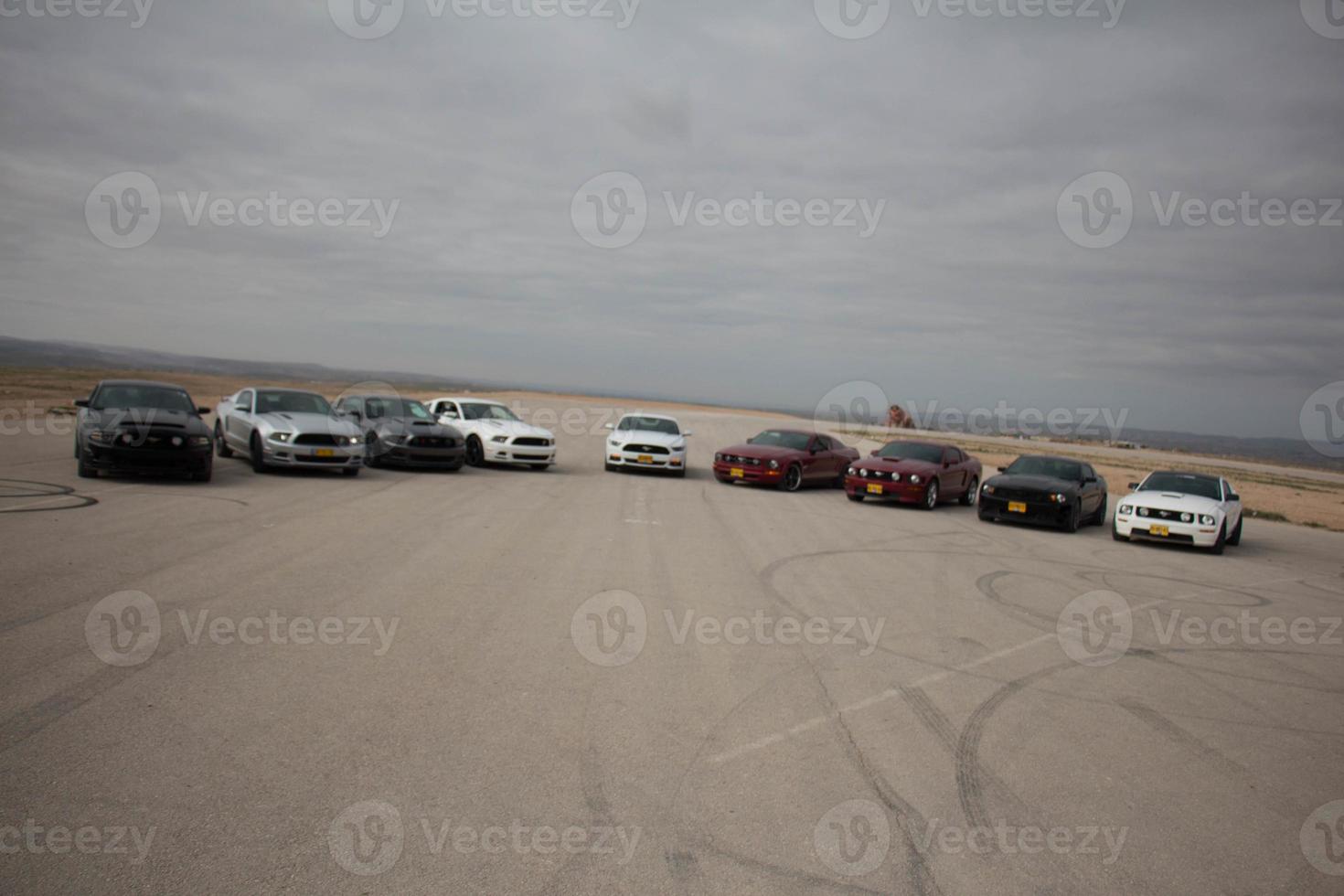 Cars on the race track and on the roads of the desert photo