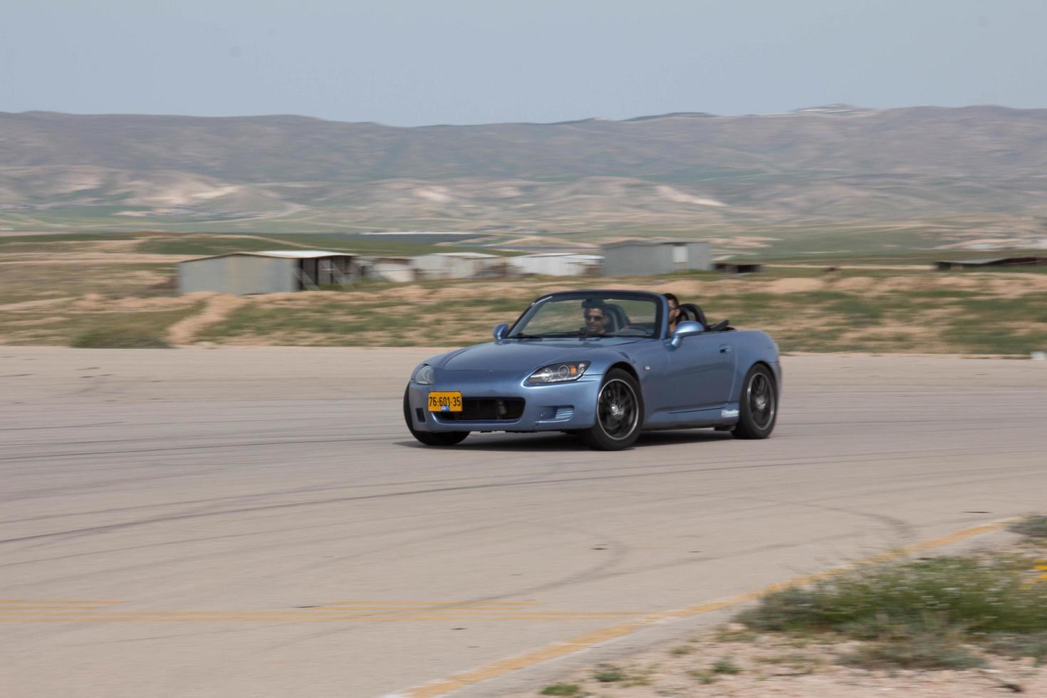 Cars on the race track and on the roads of the desert photo