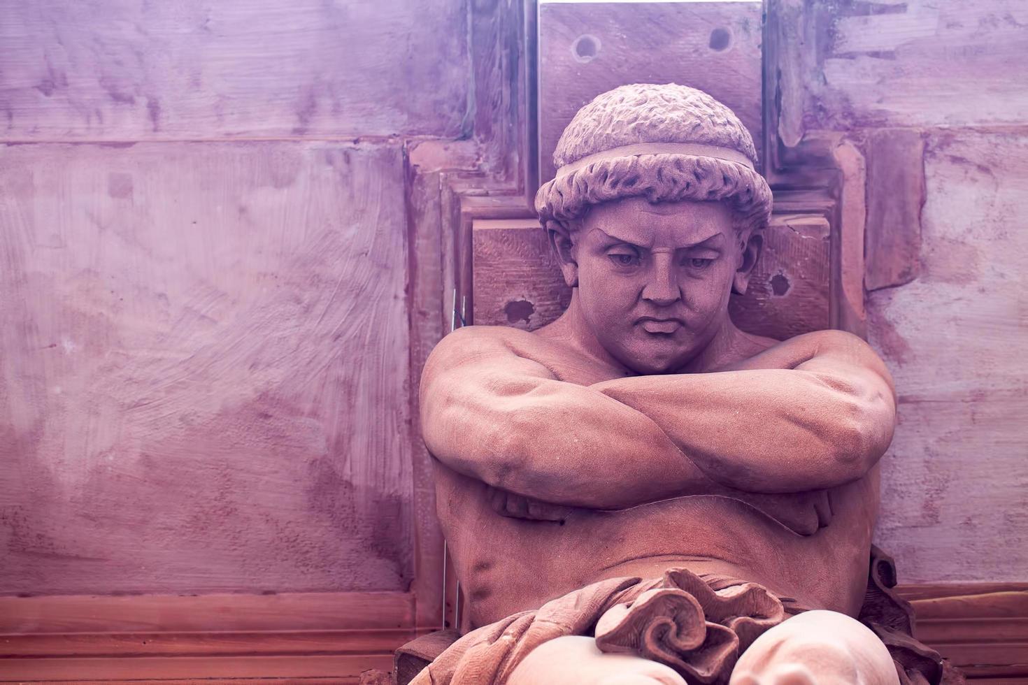 Greek God Statue on a Brick Building photo