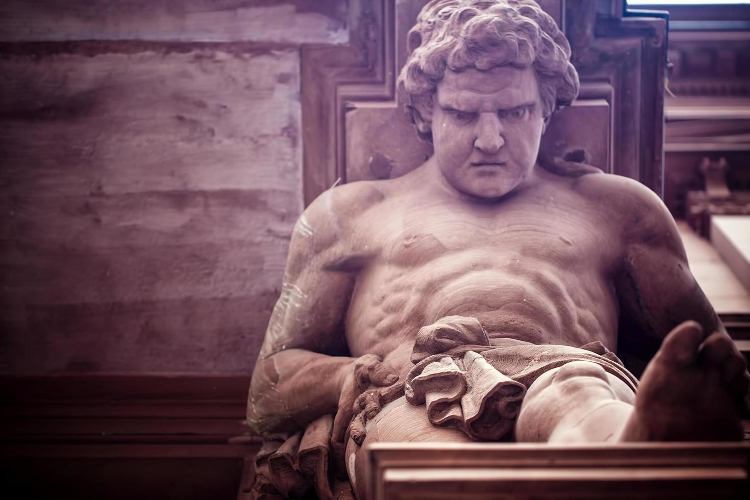 Greek God Statue on a Brick Building photo
