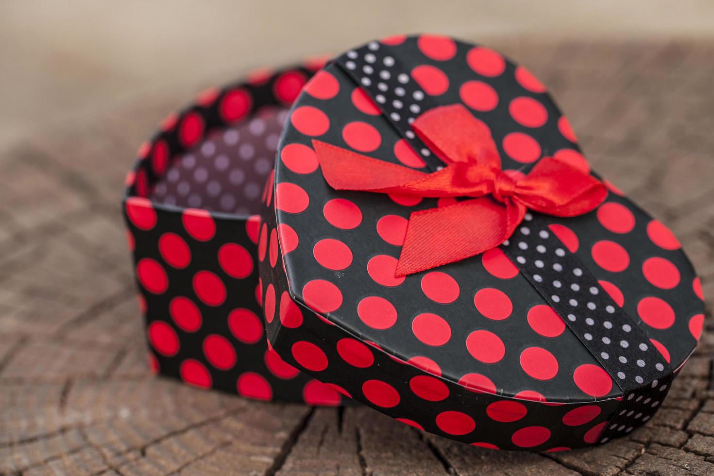 Heart Shape of Gift Box on Wood Trunk photo