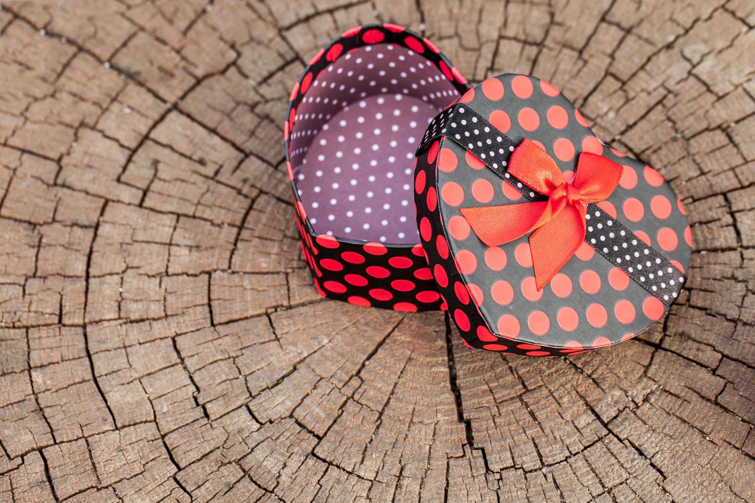 Heart Shape of Gift Box on Wood Trunk photo
