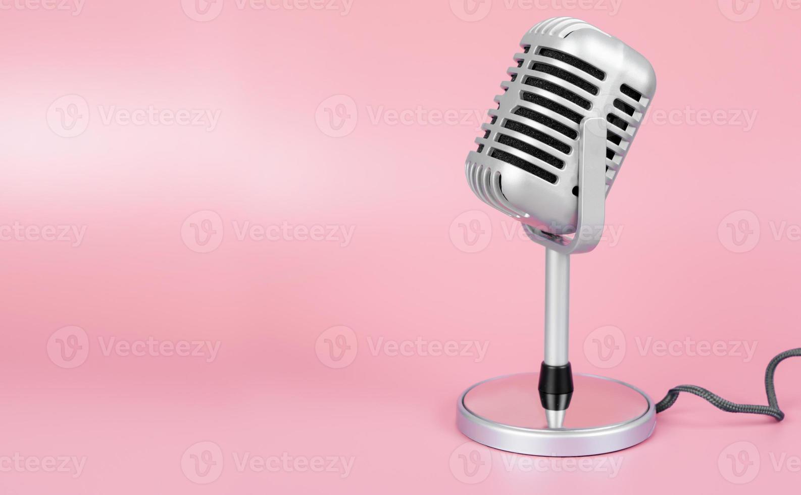 Retro microphone with copy space on pink background photo