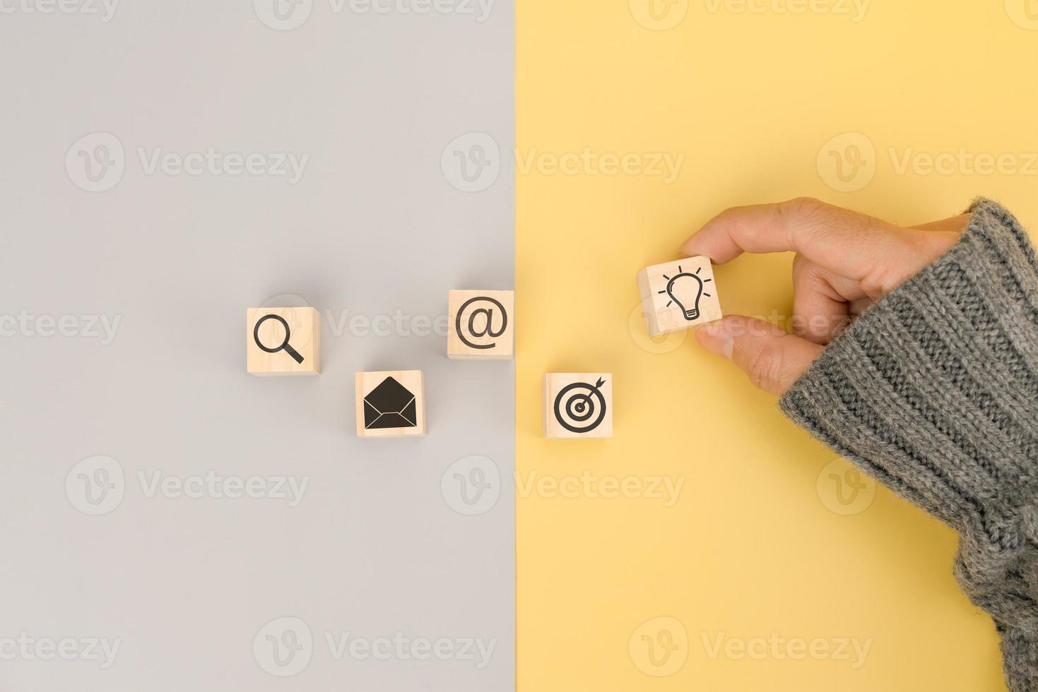 Businessman hand arranging wood block with icon business idea photo