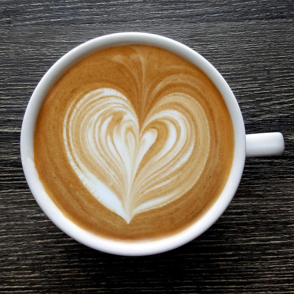 Top view of a mug of latte art coffee. photo