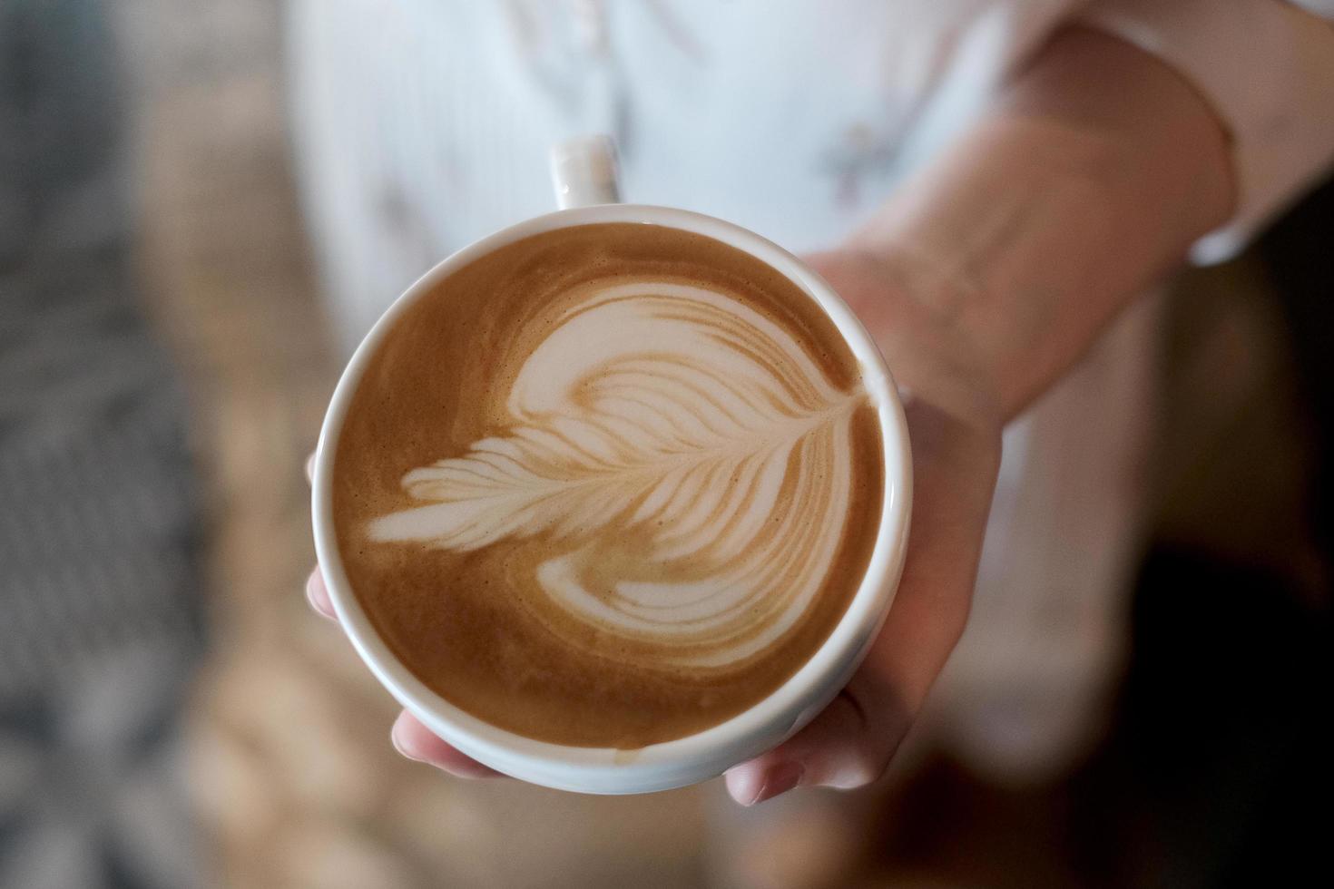 Top view of a mug of latte art coffee. photo