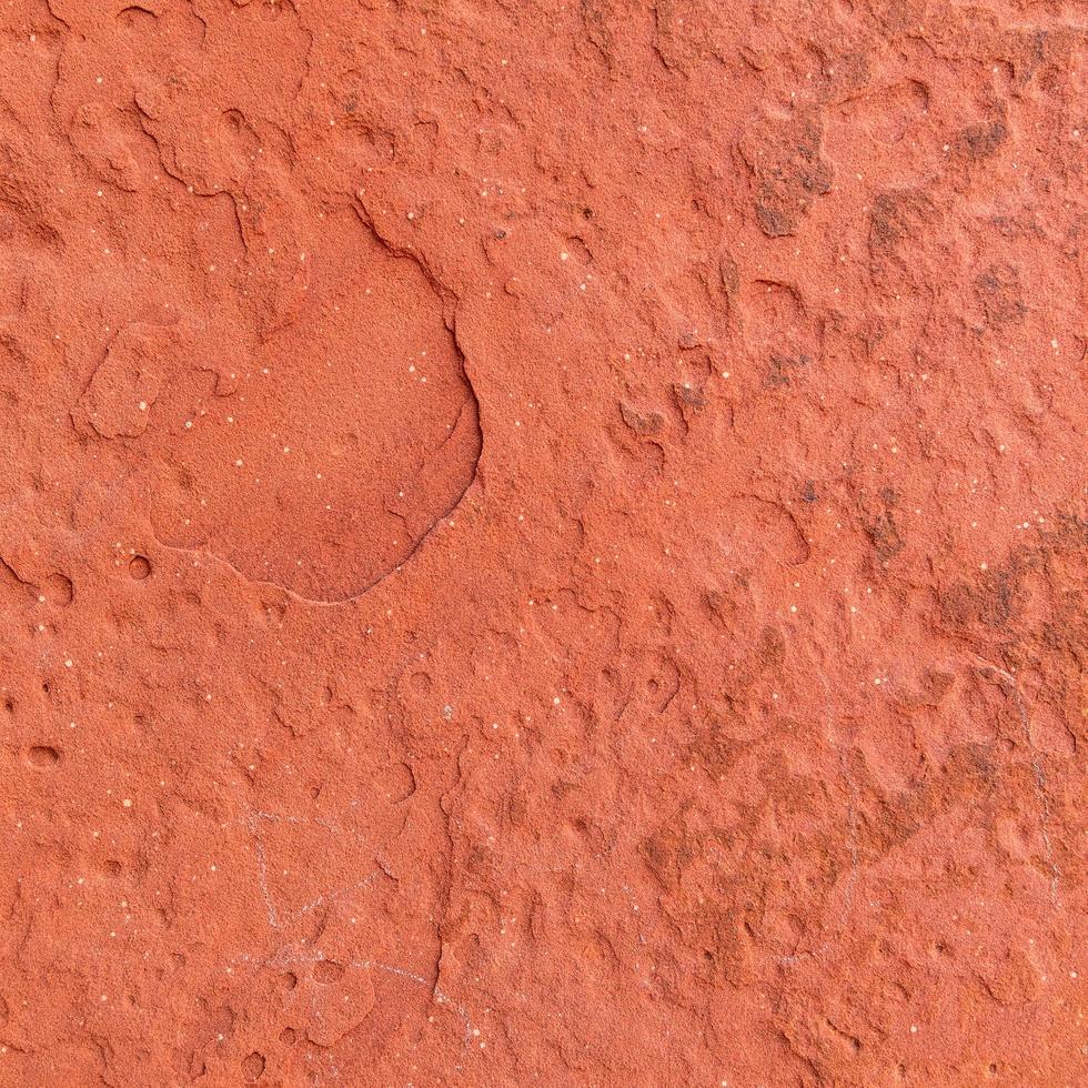 Fondo de textura de piedra rugosa roja. foto