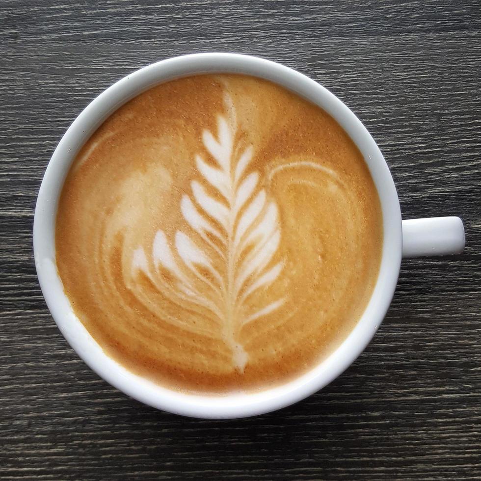 Top view of a mug of latte art coffee. photo