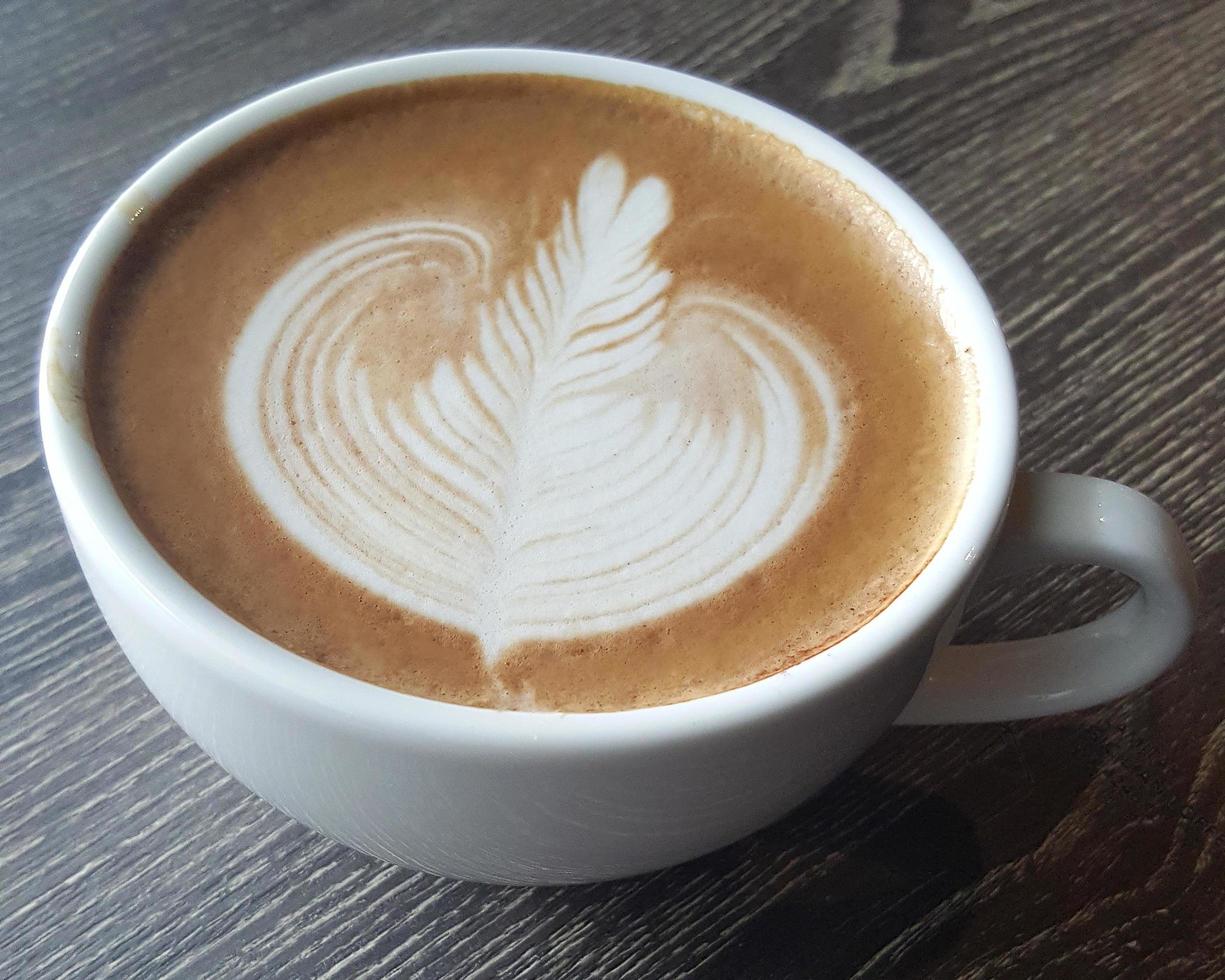 Top view of a mug of latte art coffee. photo