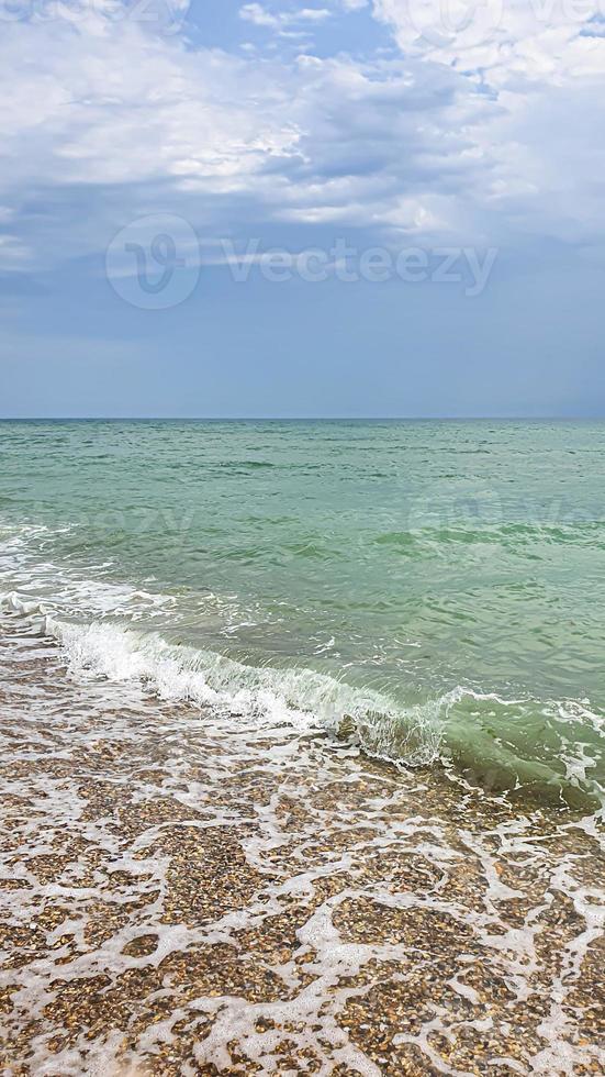 Seascape. Azure color of water, waves foaming on the shore. photo