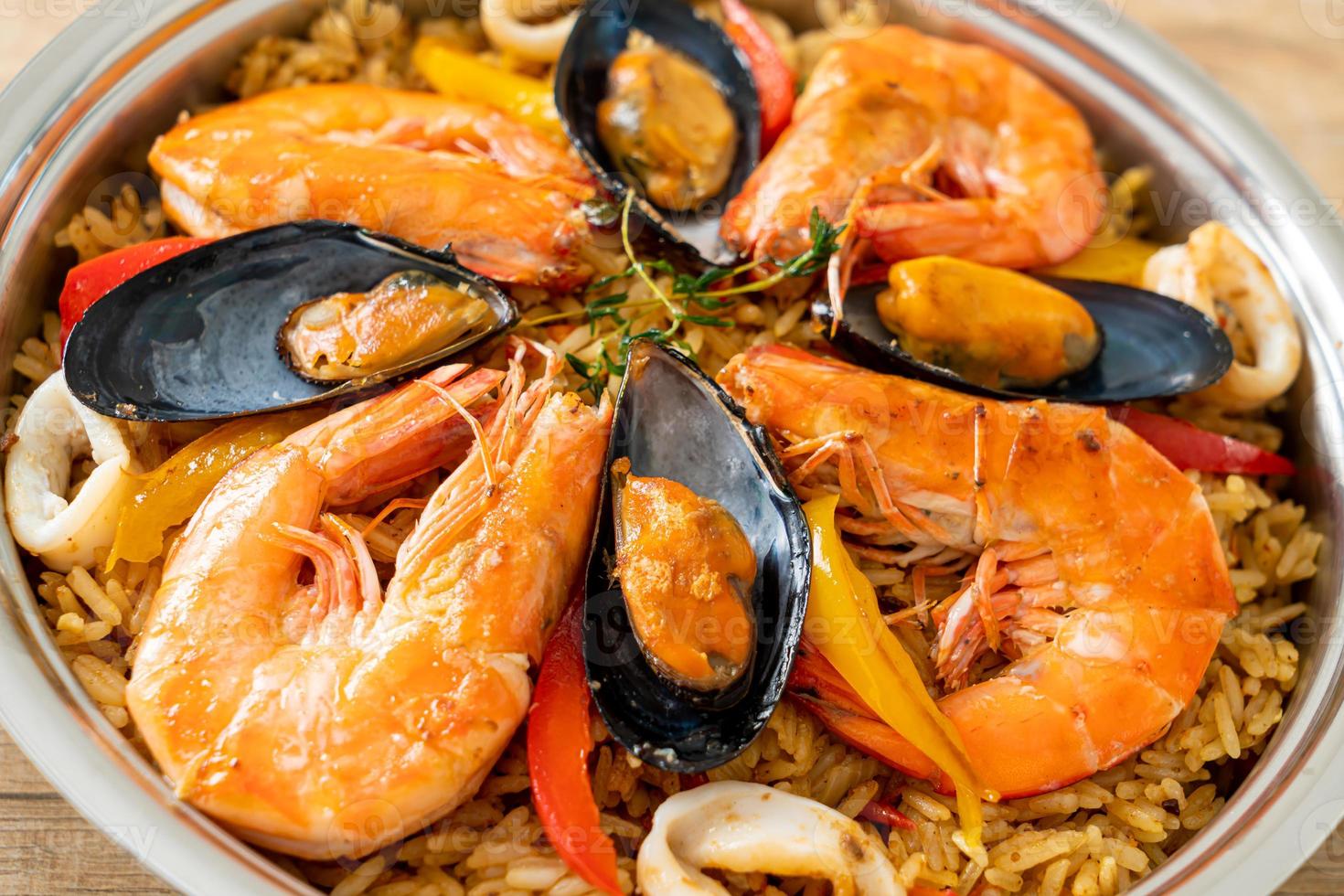 Seafood Paella with prawns, clams, mussels on saffron rice photo