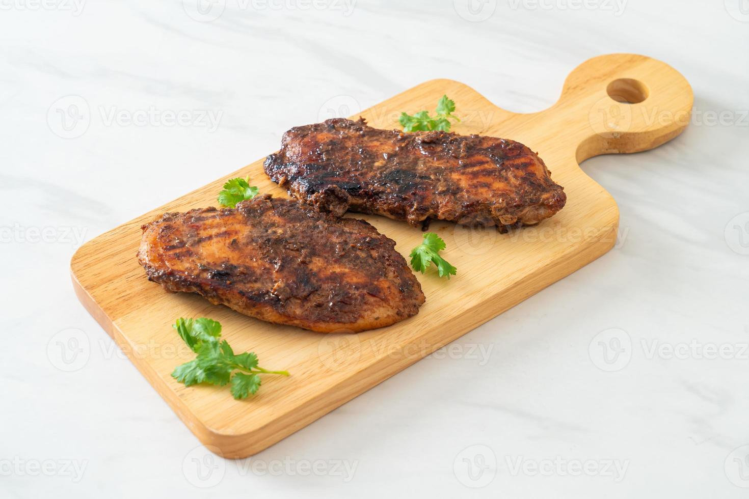 Spicy grilled Jamaican jerk chicken - Jamaican food style photo