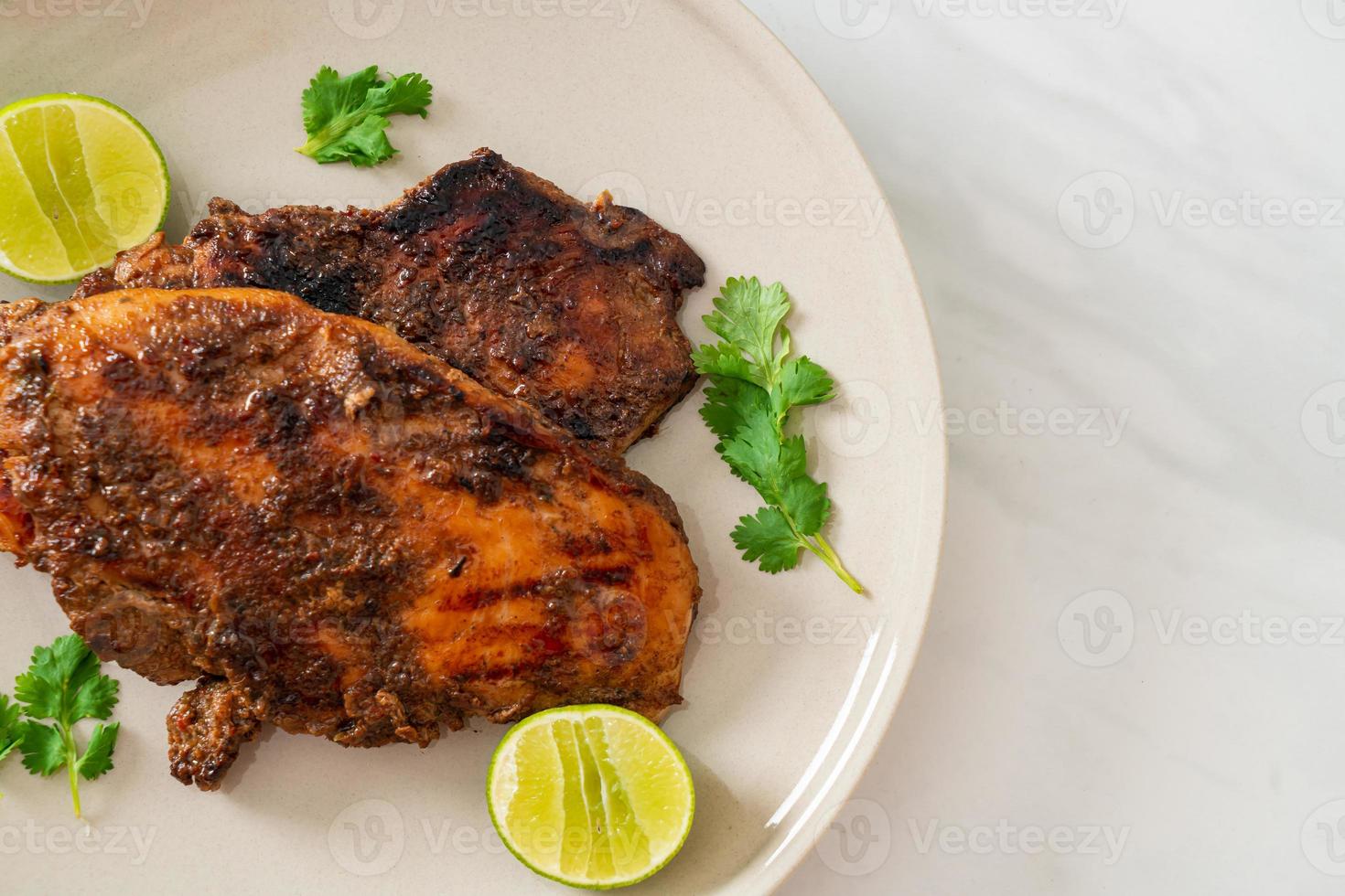 Spicy grilled Jamaican jerk chicken - Jamaican food style photo