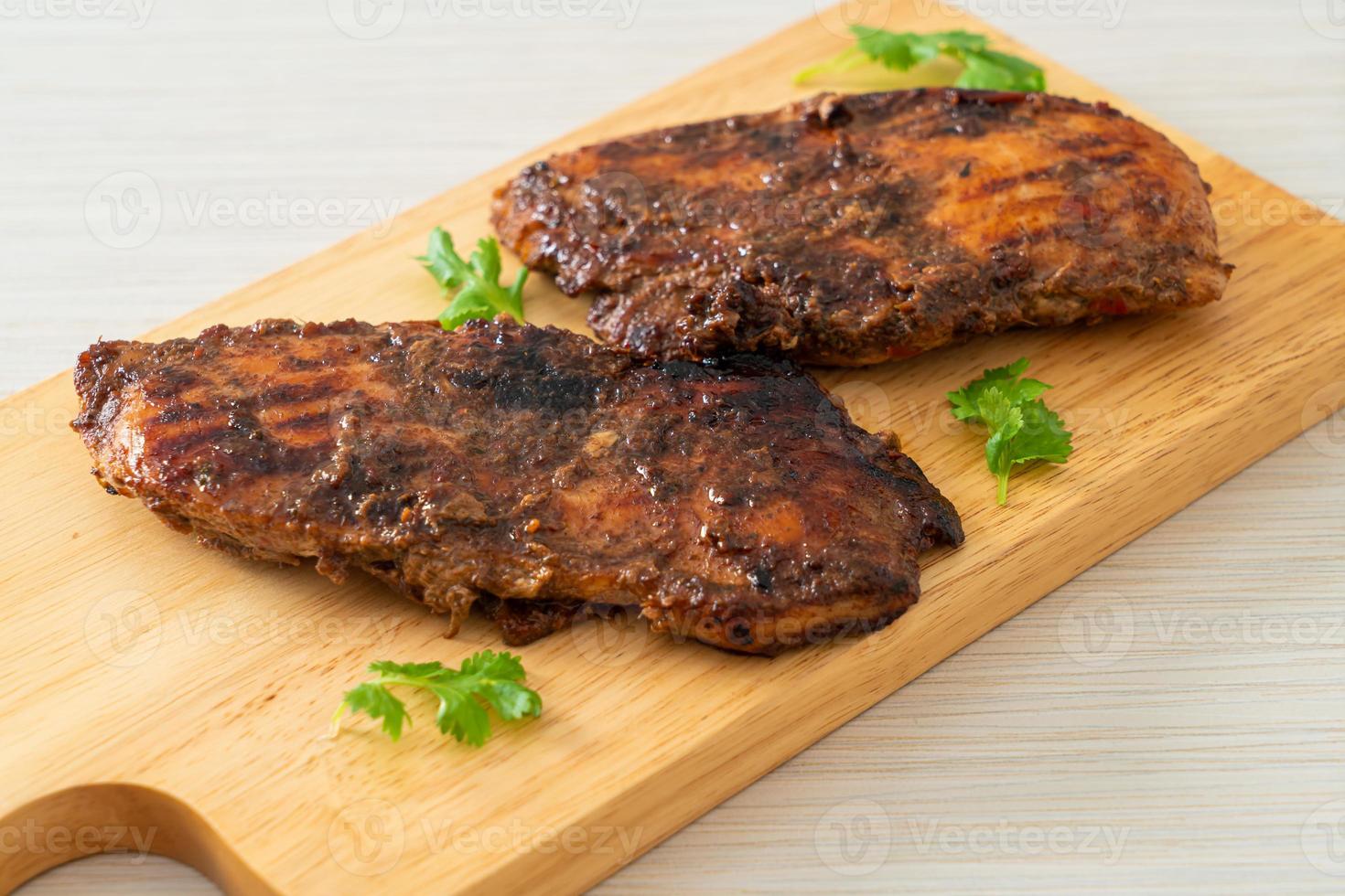 Spicy grilled Jamaican jerk chicken - Jamaican food style photo